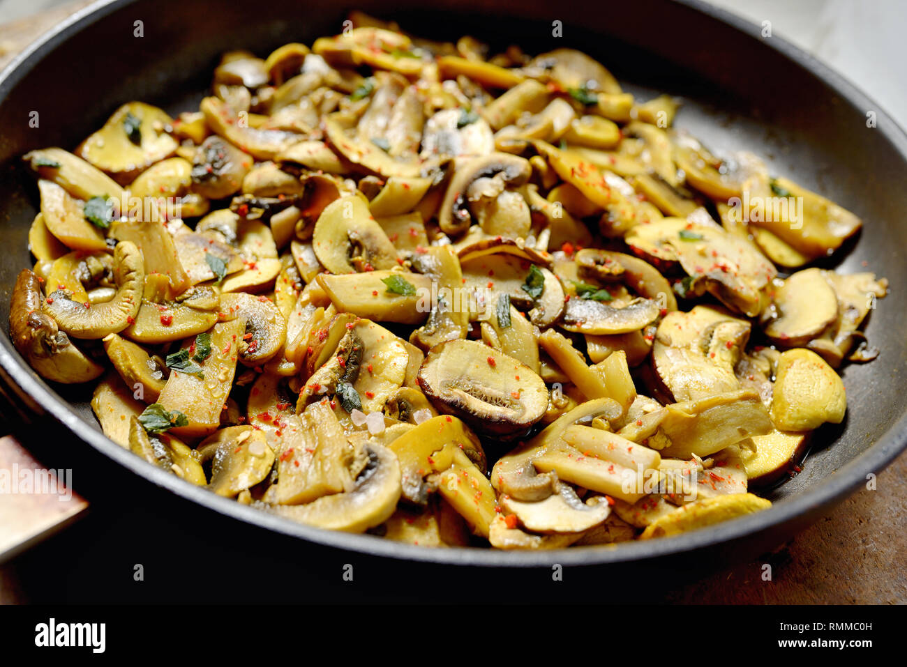 Roasted mushrooms champignons on stone table Stock Photo