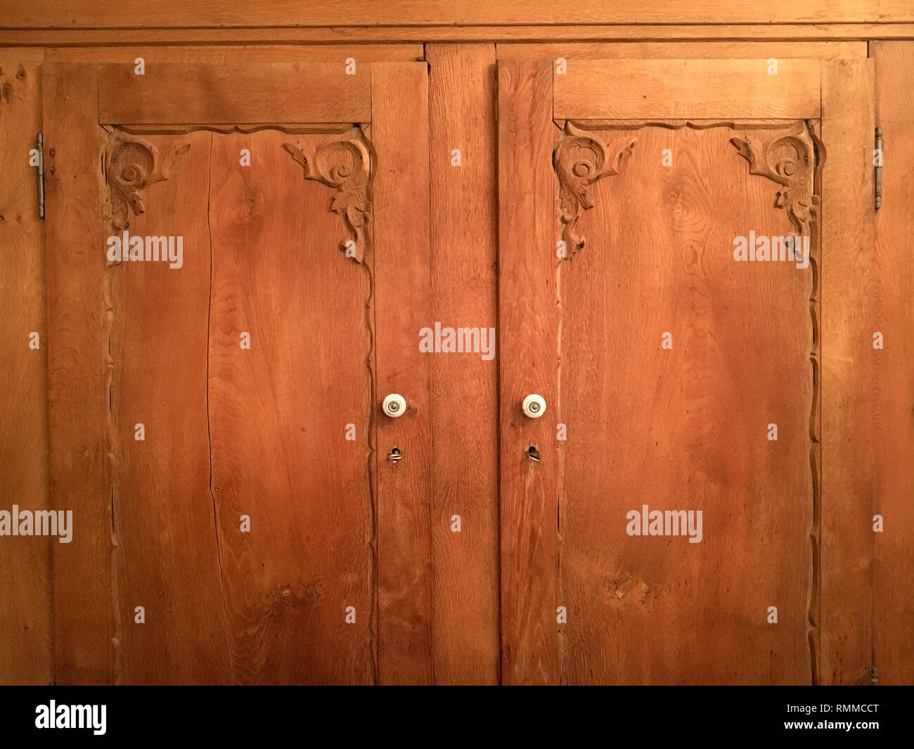 Front of wooden cabinet doors with keys and knobs. Vintage furniture. Stock Photo
