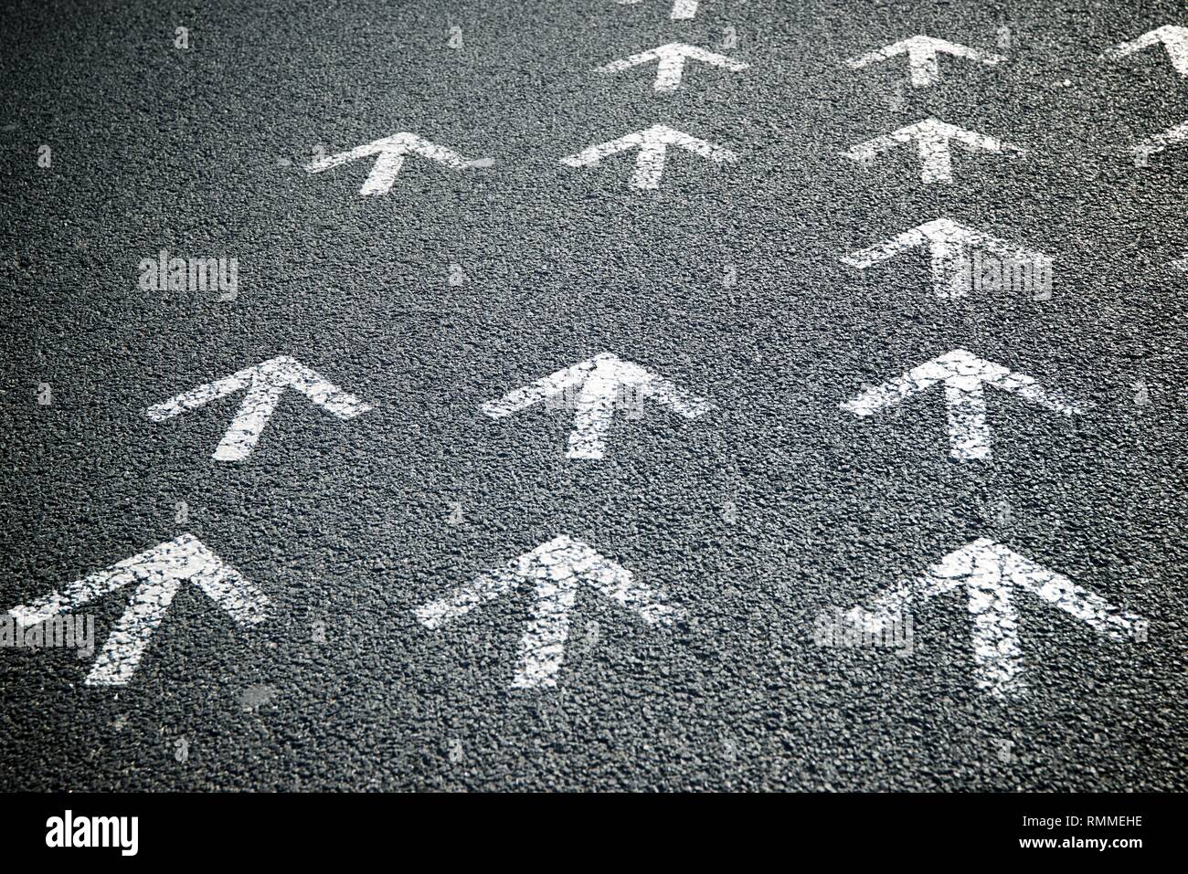 Directional arrows painted on a cement floor Stock Photo - Alamy