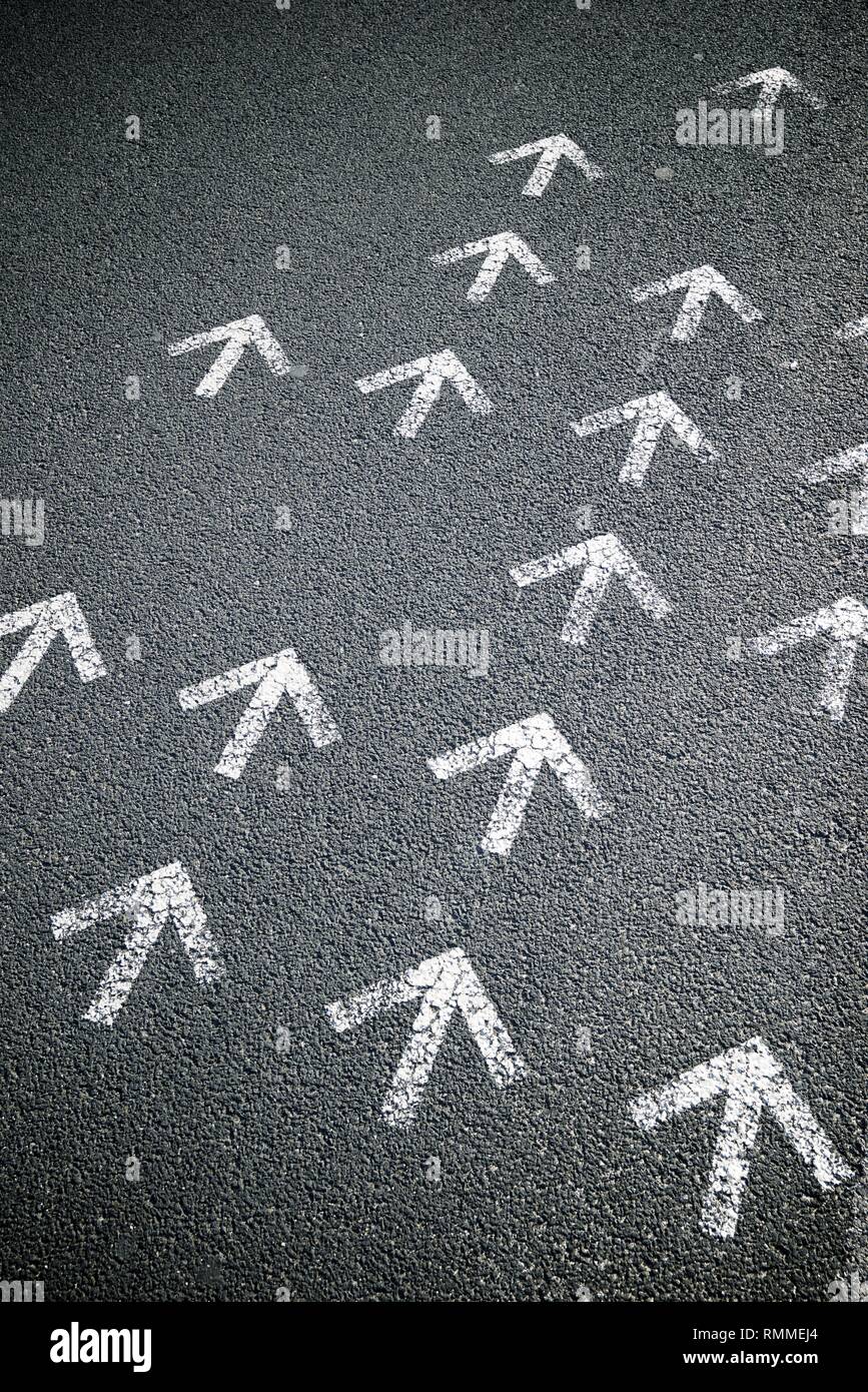 Directional arrows painted on a cement floor Stock Photo - Alamy