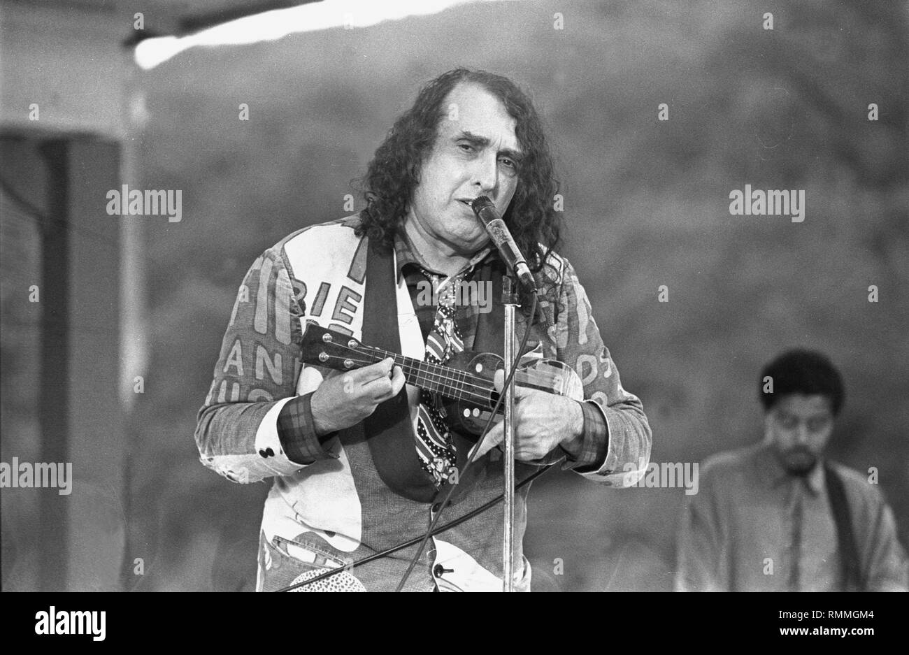 Singer, ukulele player, and musical archivist, Herbert Khaury, better known by the stage name Tiny Tim, is shown performing on stage during a 'live' concert appearance. Stock Photo