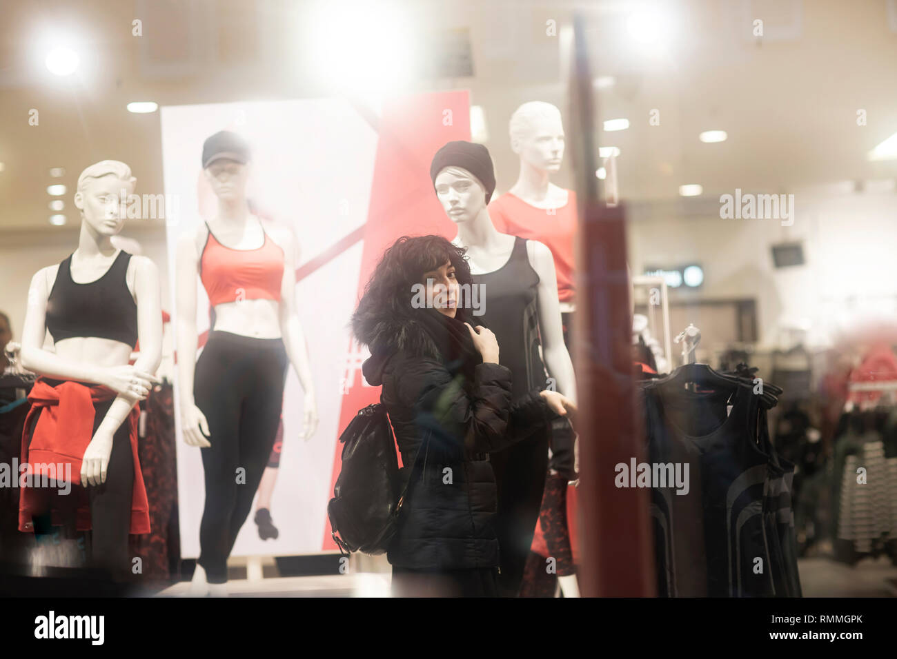 Woman standing in a shop looking at clothes, Germany Stock Photo Alamy