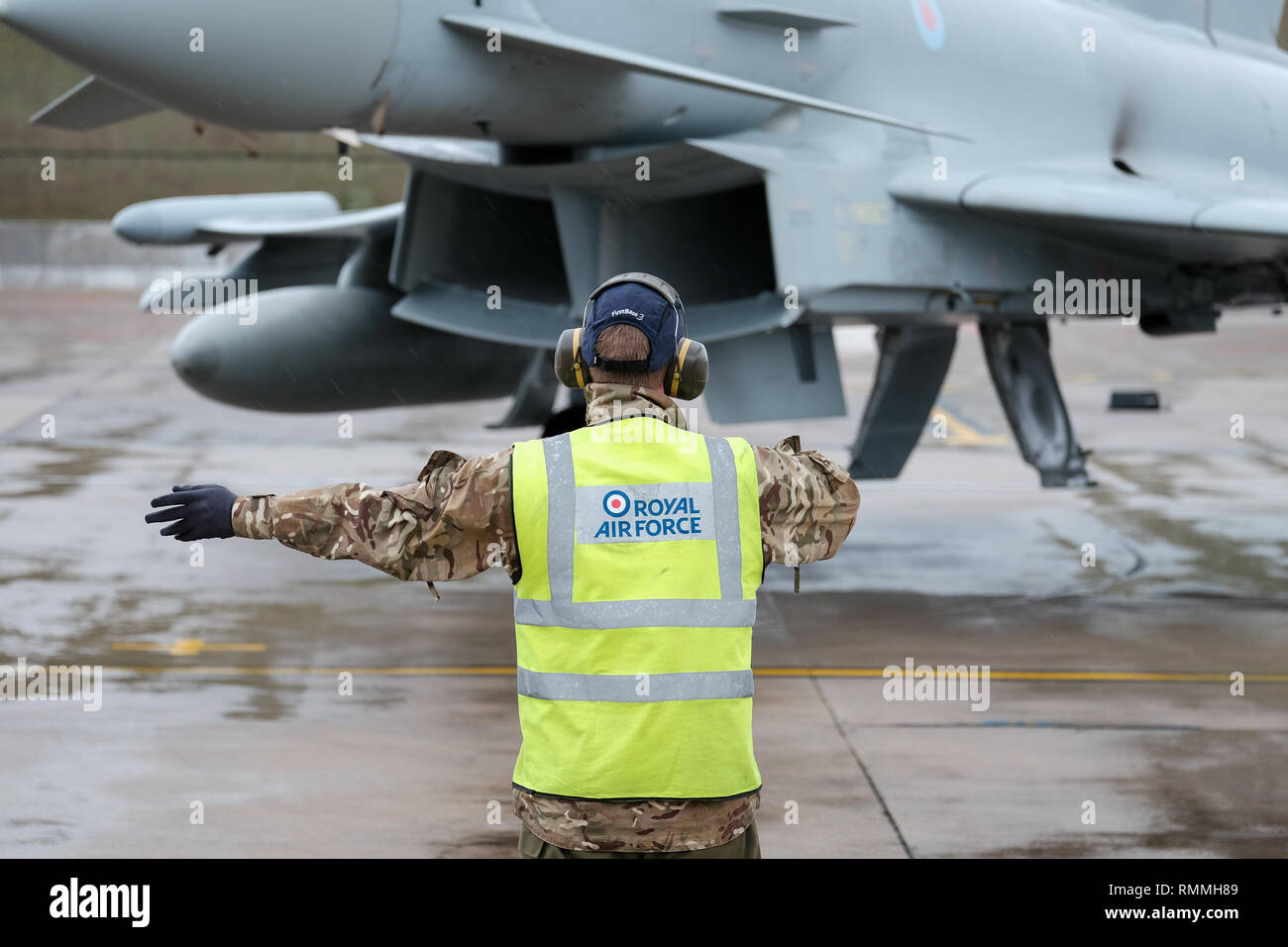 Ground crew signal an RAF Tornado jet fighter for take-off at RAF Lossiemouth base, Moray, Scotland Stock Photo