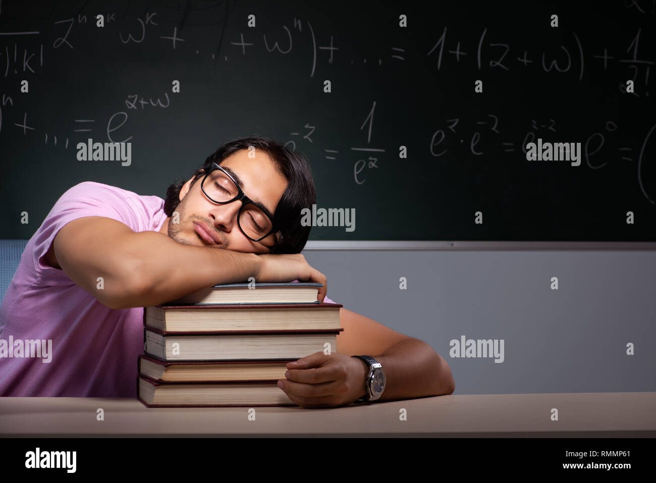Young male student sitting in classroom Stock Photo - Alamy