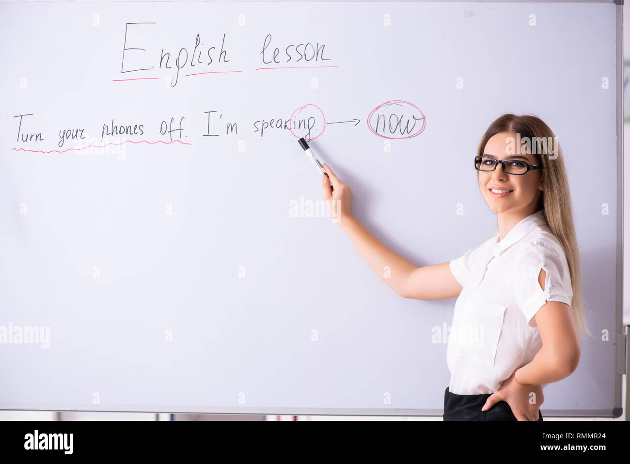 Young female english language teacher standing in front of the