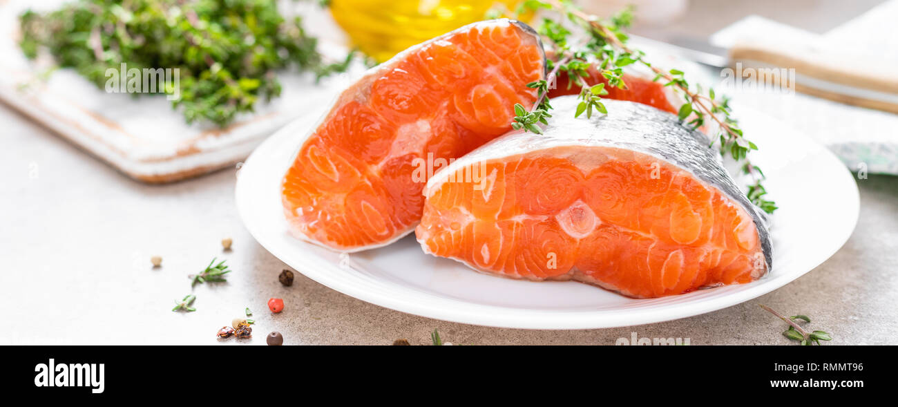 Fresh raw salmon fish steaks on white kitchen background. Banner Stock ...