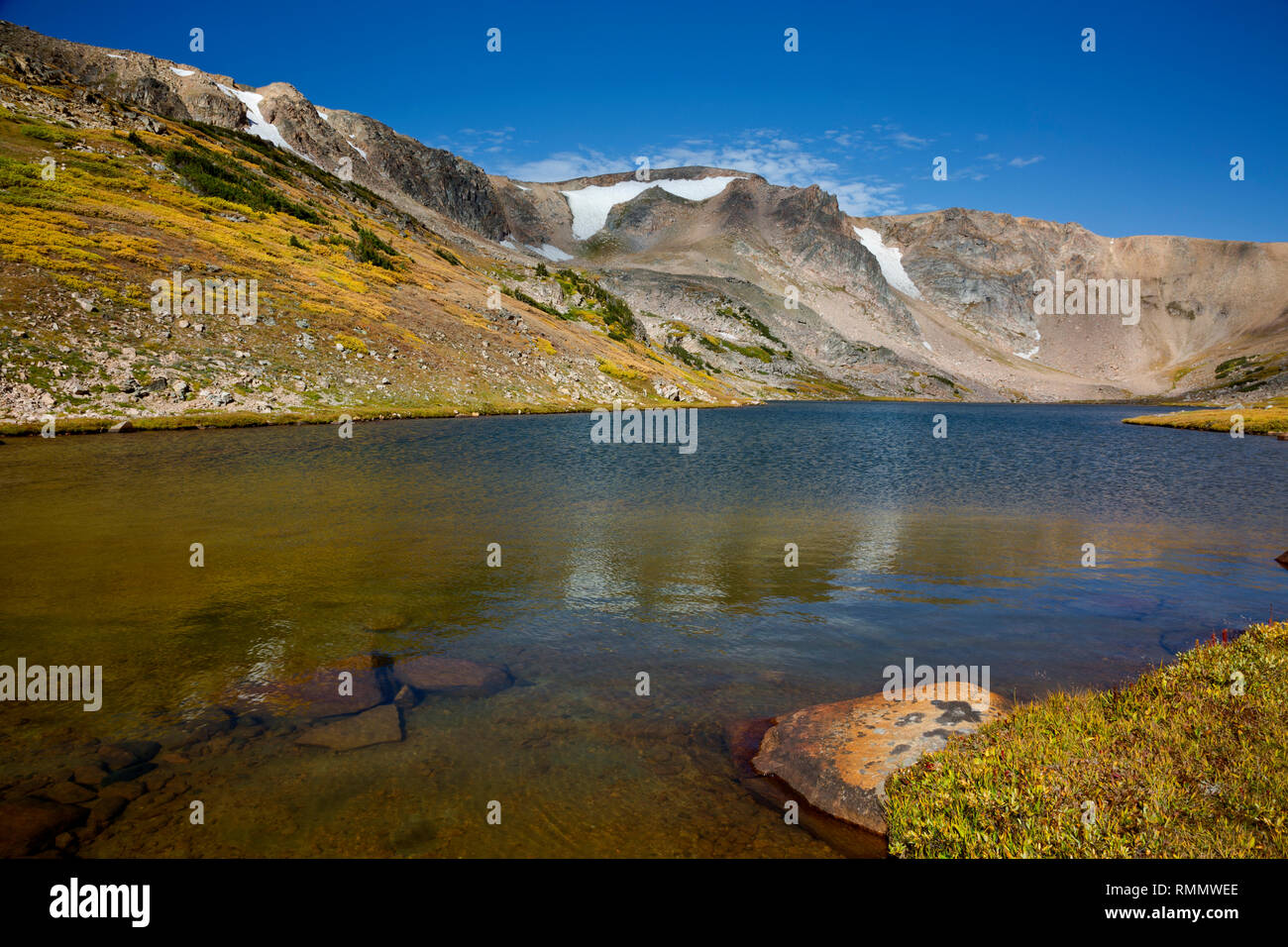 WY03730-00...WYOMING - Fall color on the hills and shore around Gardner Lake located on the Beartooth Loop National Recreation Trail in the Shoshone N Stock Photo