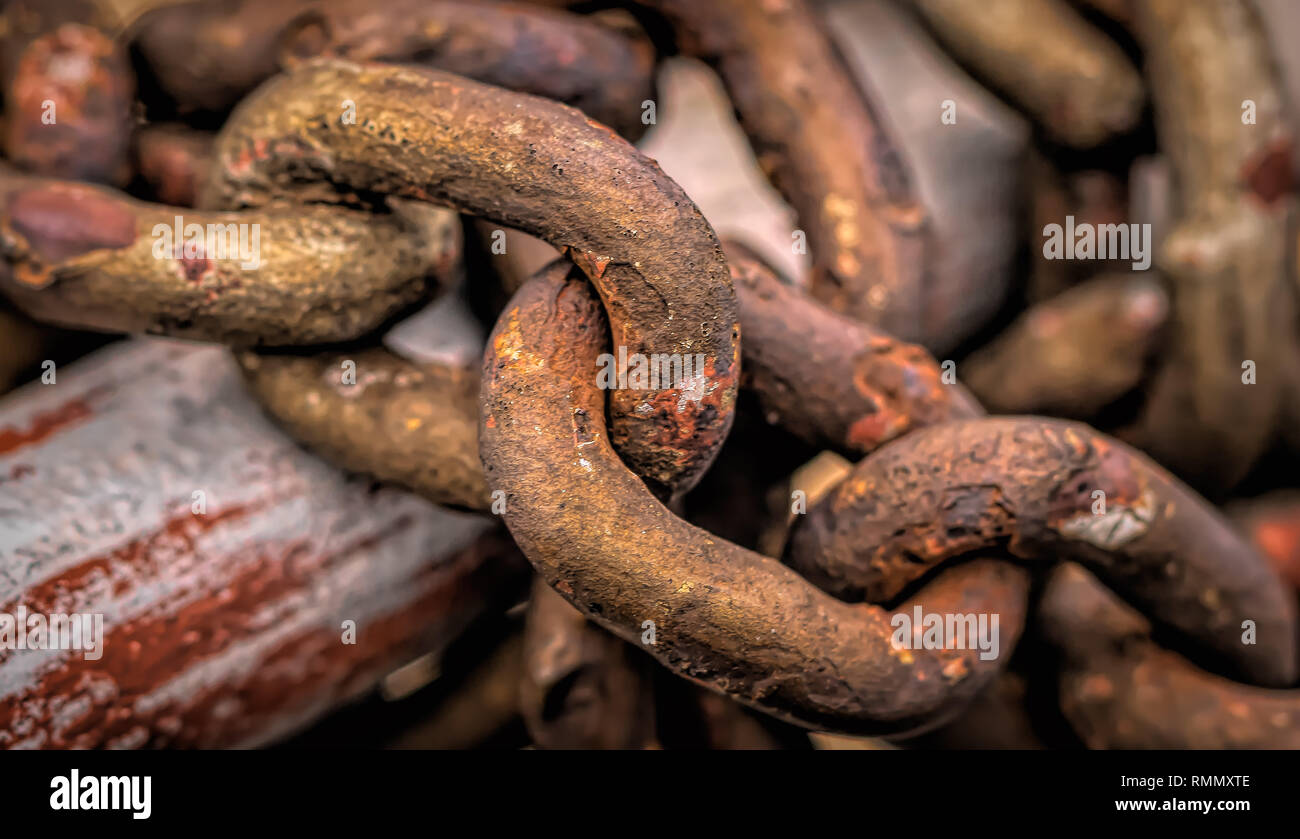 steel chain weighs on railing Stock Photo
