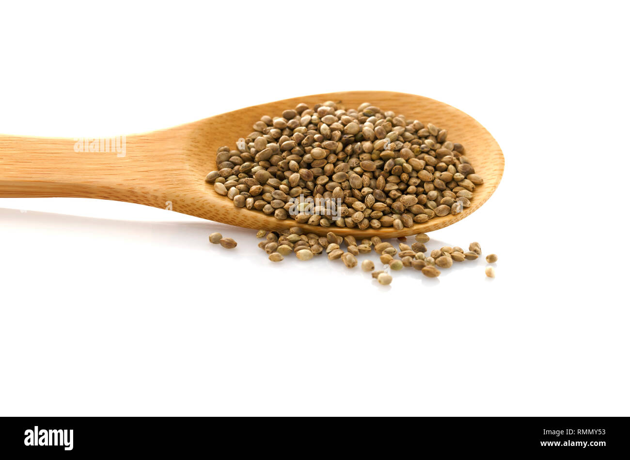 Hemp seed. Wooden spoon with hemp. Food additive. Isolated on white background. Cannabis. Stock Photo