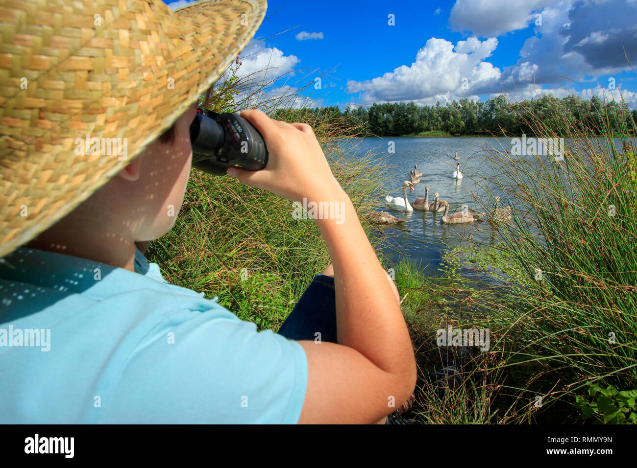 Le Plessis-Brion (northern France): ponds of Plessis-Brion, bird sanctuary. Boy observing nature through binoculars Stock Photo