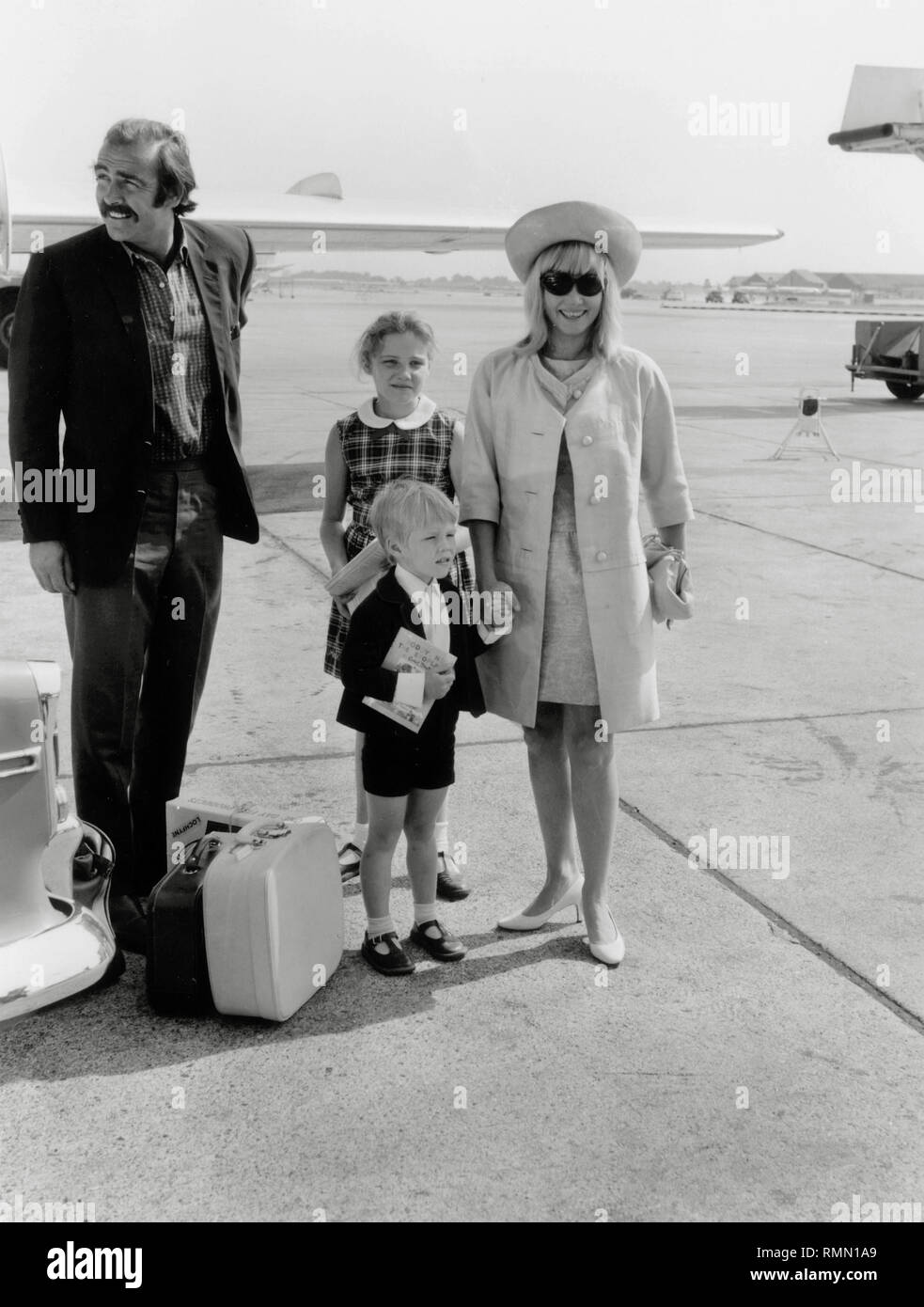 Sean Connery, with his wife, Diane Cilento,  and children, Jason Connery and Giovanna (Gigi) Volpe, at London Airport (1967)  File Reference # 33751 274THA Stock Photo