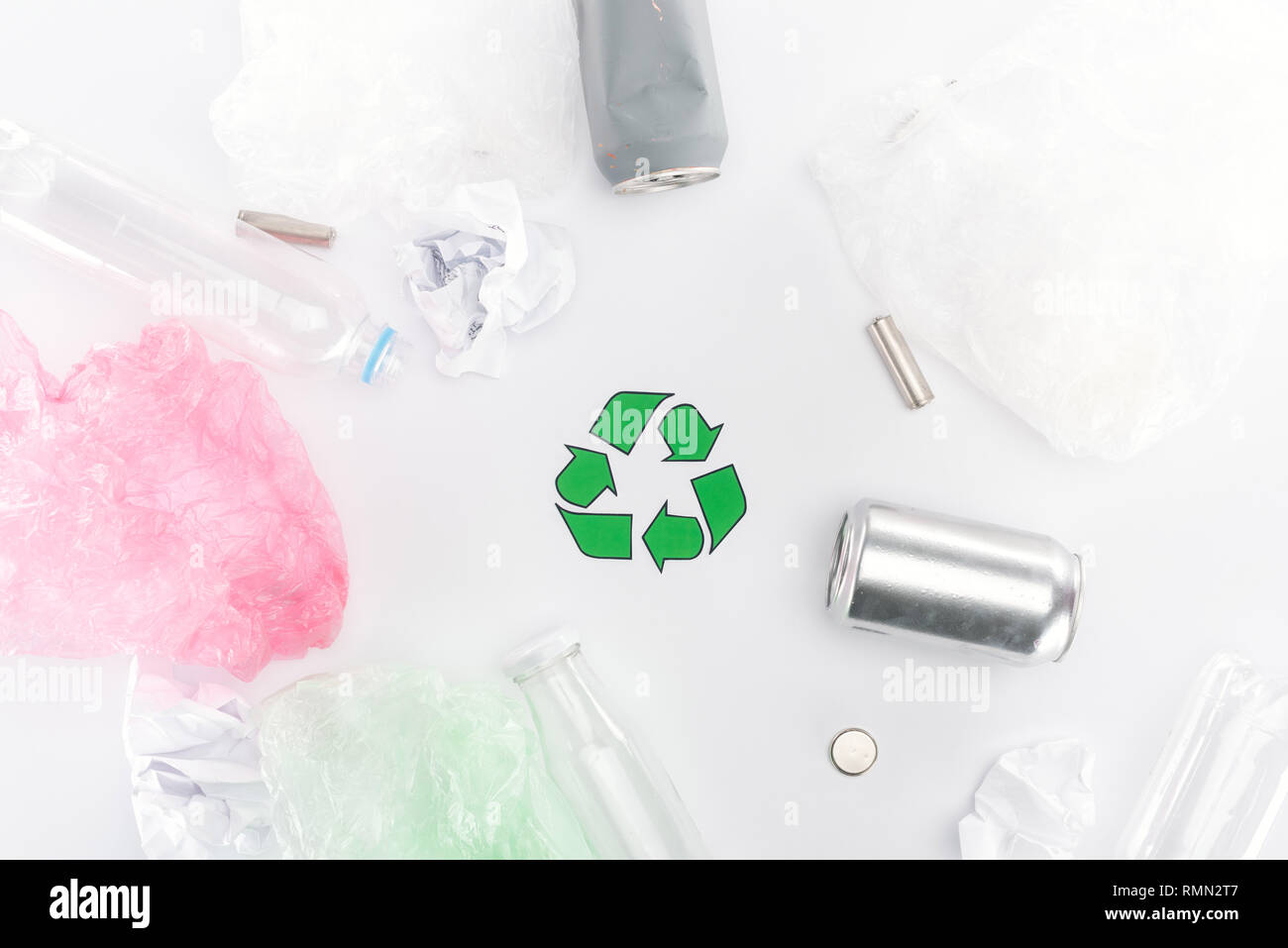 Top view of cans, plastic bags, paper, recycling sign, plastic and glass bottles Stock Photo