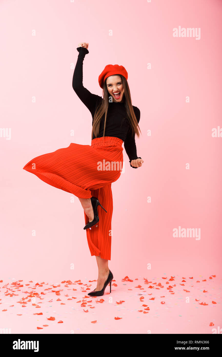Full length portrait of a beautiful young woman wearing red beret