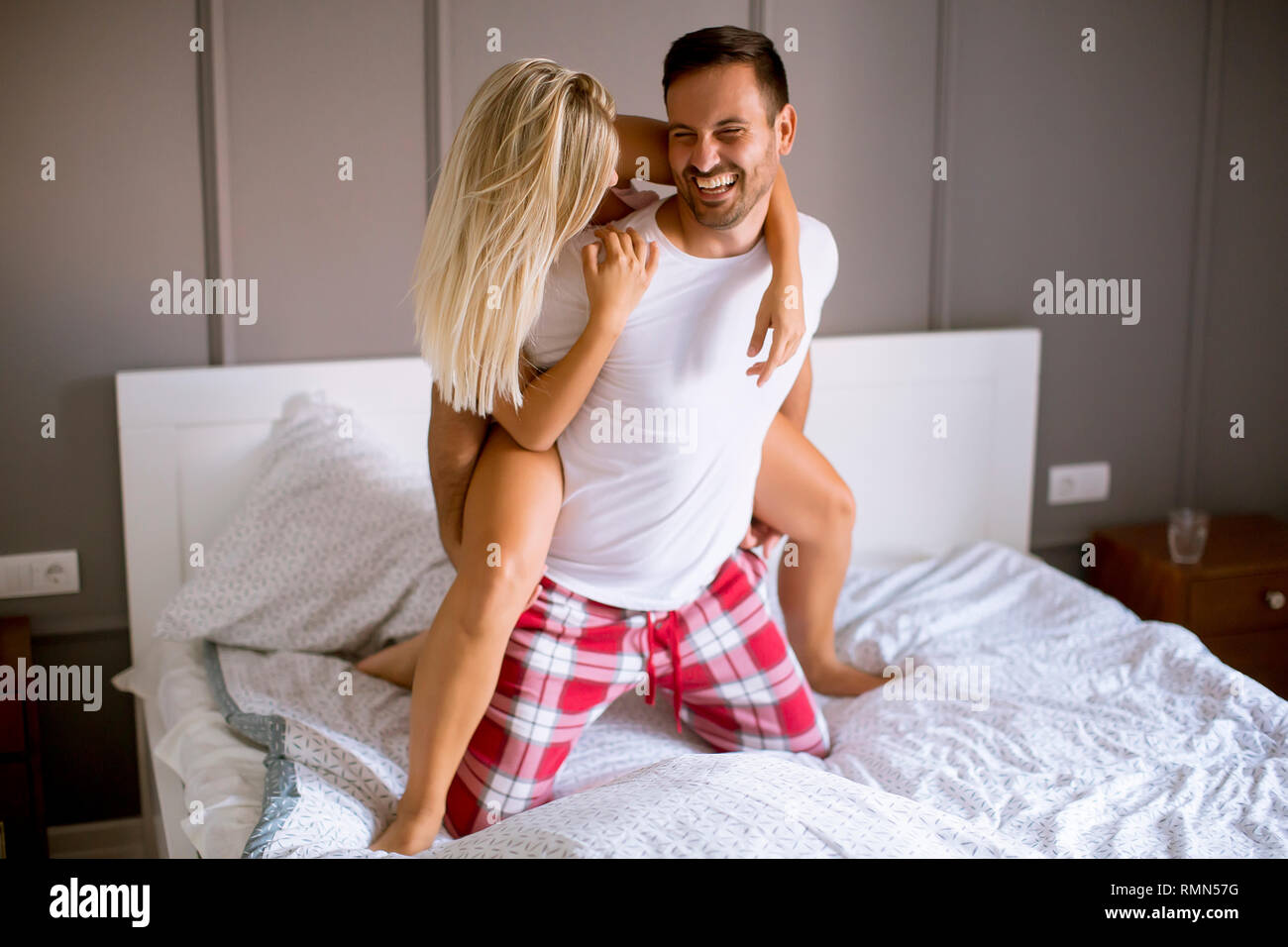 Loving Young Couple Having Fun In The Bed At Bedroom Stock