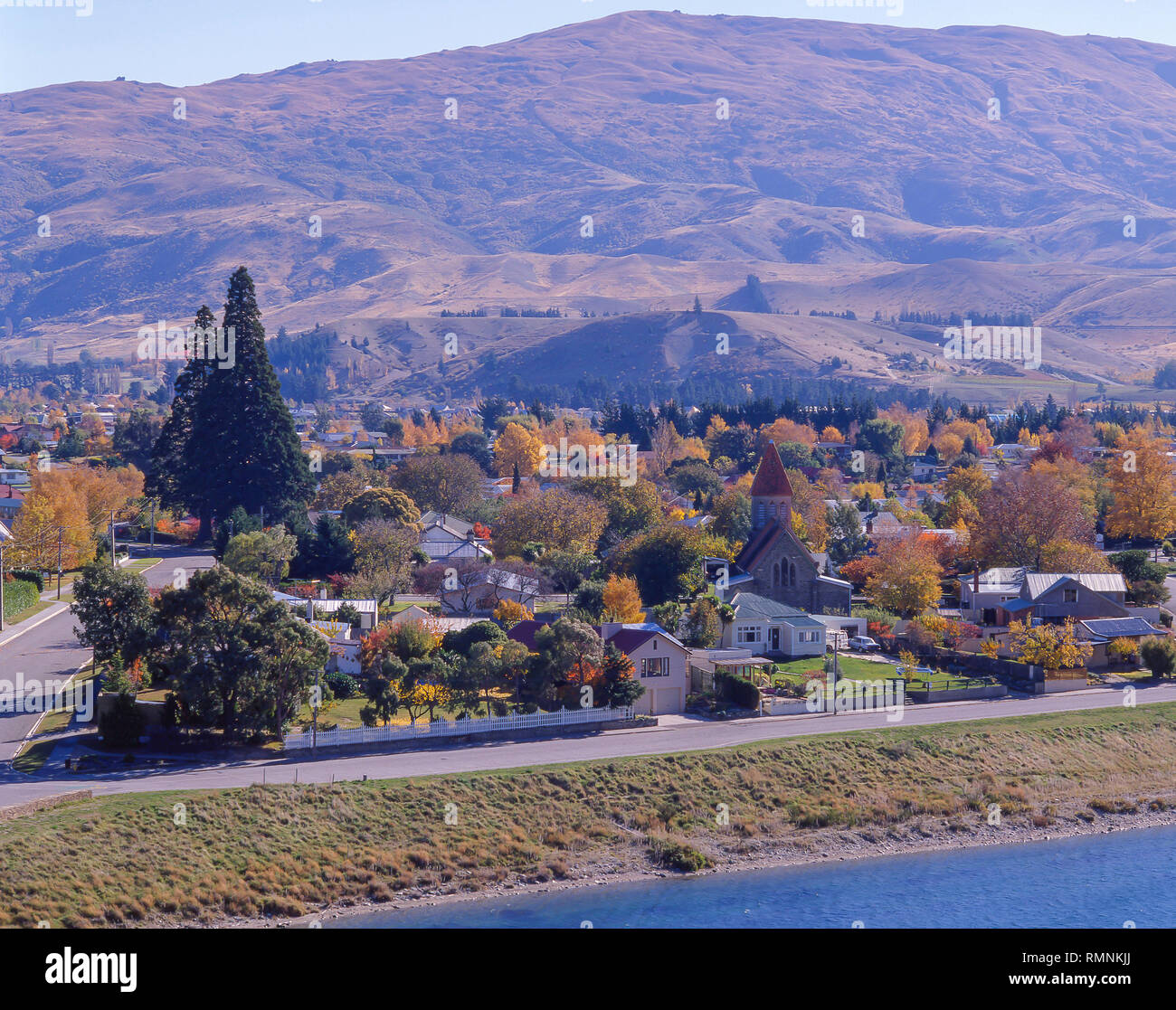 View of town acoss Lake Dunstan in autumn, Cromwell, Otago Region, South Island, New Zealand Stock Photo