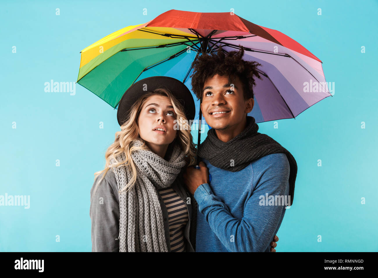 Smiling Multiracial Teenage Couple Wearing Winter Clothes Standing 