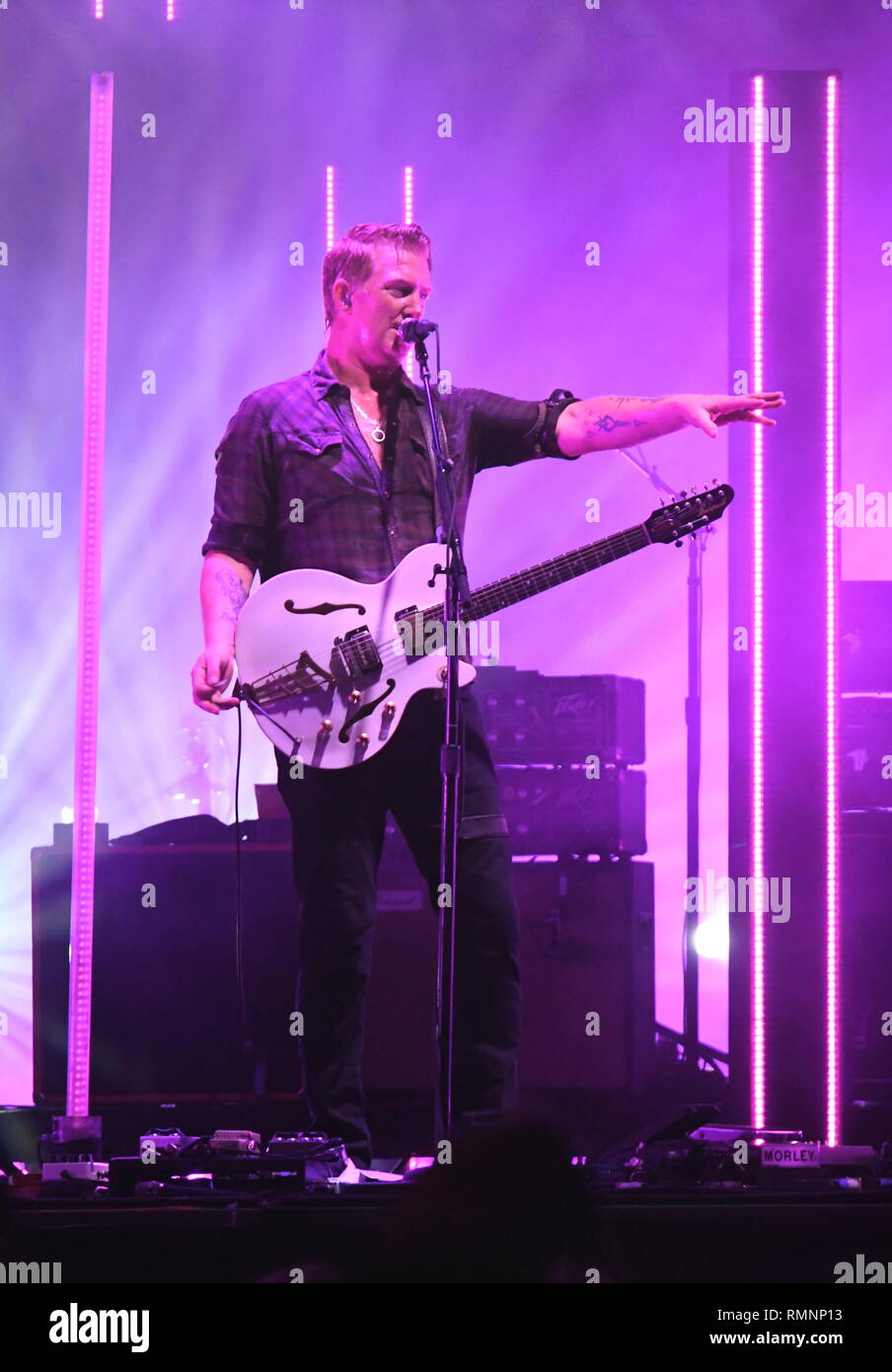 Musician Josh Homme and Queens of the Stone Age are shown performing on stage during a 'live' concert appearance. Stock Photo