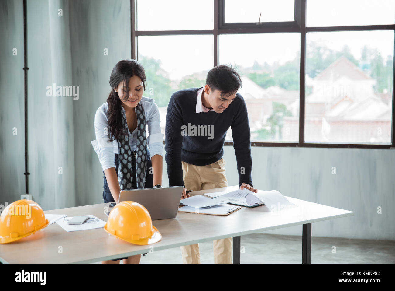 young architect discussing their project in the office with partner