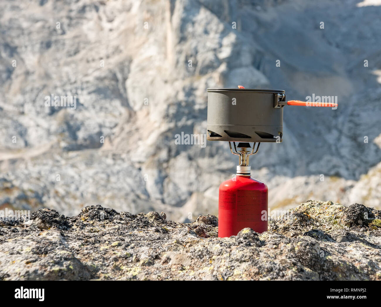 Tourist equipment and tools: camping gas over Marmolada mountain background Dolomites Italy Stock Photo