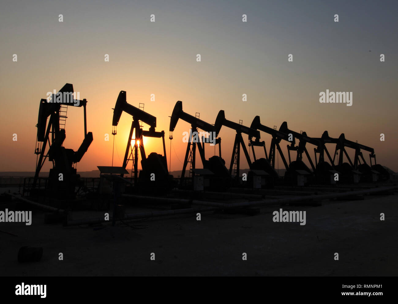 Oil pumps work in the desert oil fields of Sakhir, Bahrain. (Photo