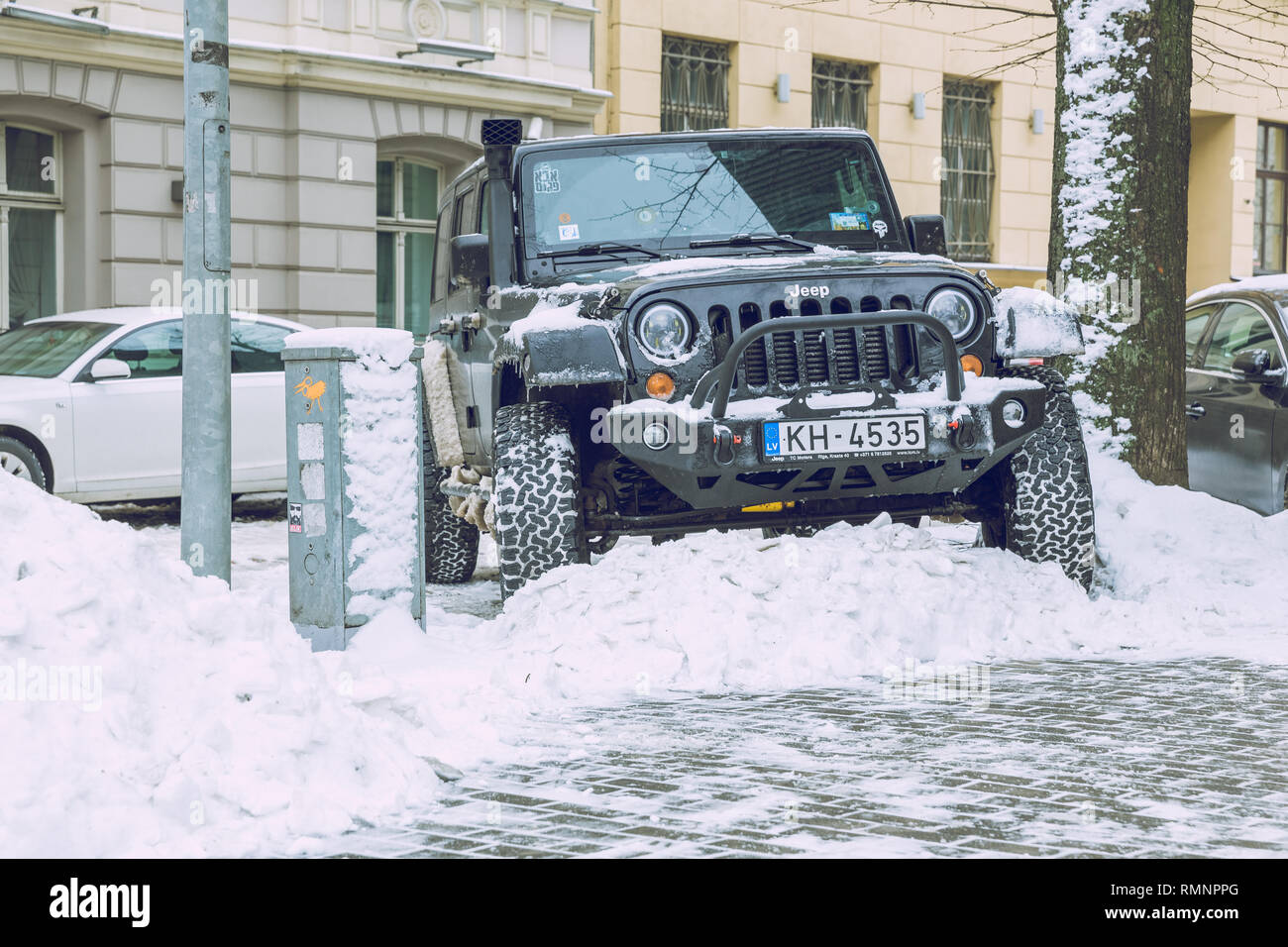 City Riga, Latvia. Jeep wrangler, black color, urban city street. Snow and cold weather. Travel photo 2019 february. Stock Photo