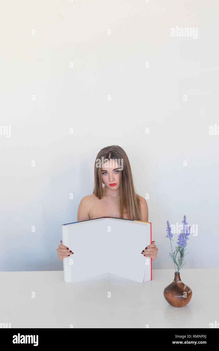 Girl with book over white background Stock Photo - Alamy