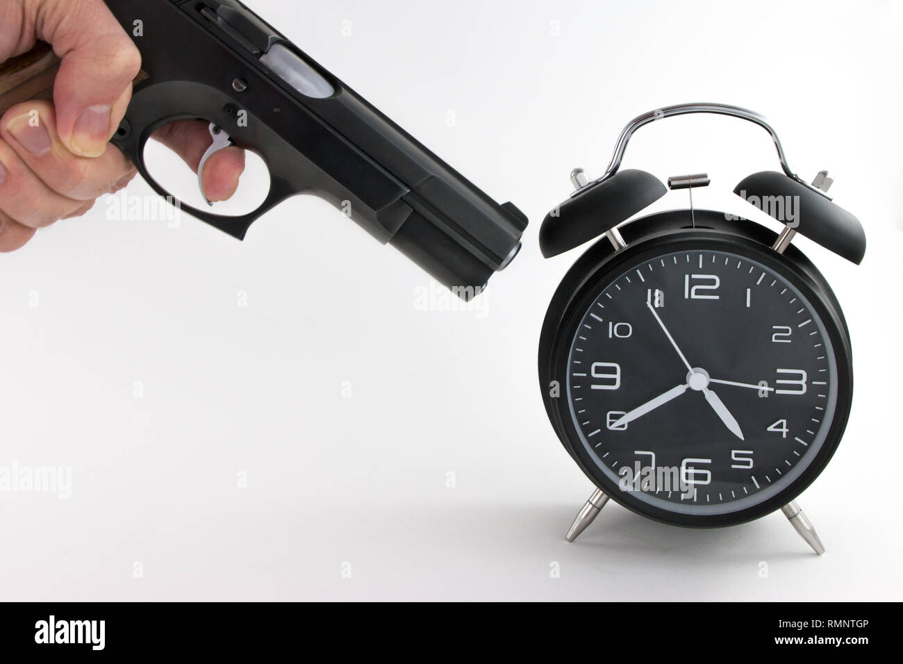 Vintage Alarm Clock with gun on white background Stock Photo - Alamy