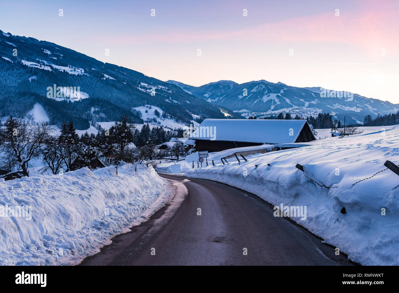 Empty asphalt road in winter Birnberg, Schladming, Schladming-Dachstein, Dachstein massif, Liezen District, Styria, Austria, Europe Stock Photo