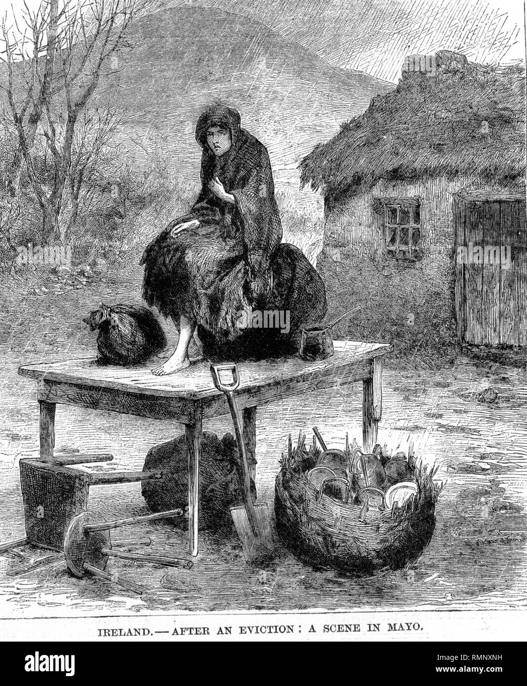 print of a wood engraving from 1886 showing an irish girl out in the rain after an eviction scene in county mayo with household belongings Stock Photo