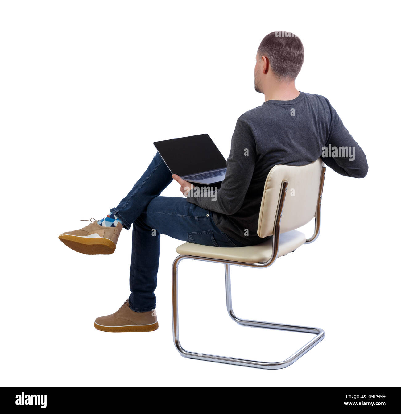 Back view of a man who sits on a chair with a laptop.  Rear view people collection.  backside view of person.  Isolated over white background. Side vi Stock Photo