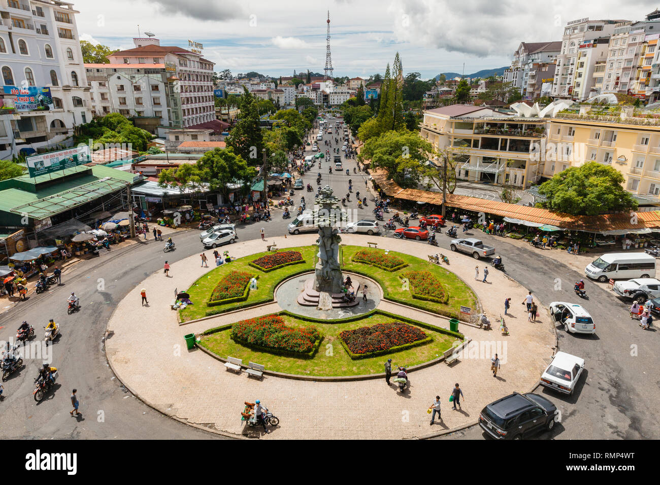 Dalat, Vietnam - September 23, 2018: People walk and ride a motorbike at the central Market Square on September 23, 2018, in Dalat, Vietnam Stock Photo