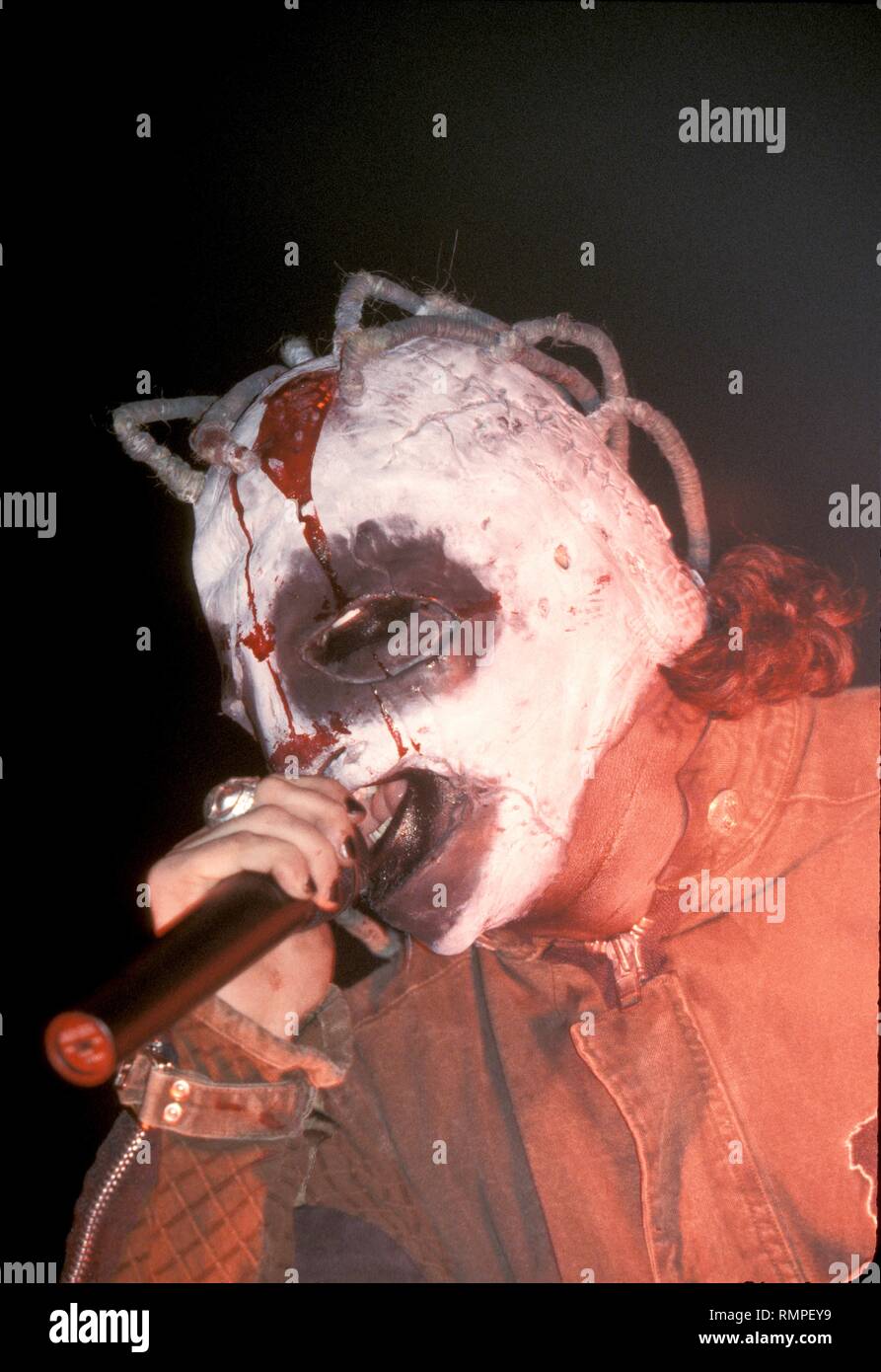 A Slipknot band member is shown performing on stage during a 'live' concert appearance. Stock Photo