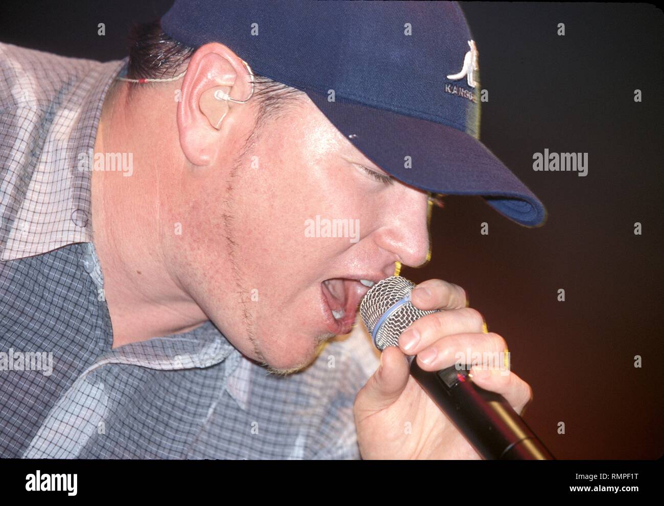 Lead singer Steve Harwell of the pop rock band Smash Mouth is shown performing on stage during a 'live' concert appearance. Stock Photo