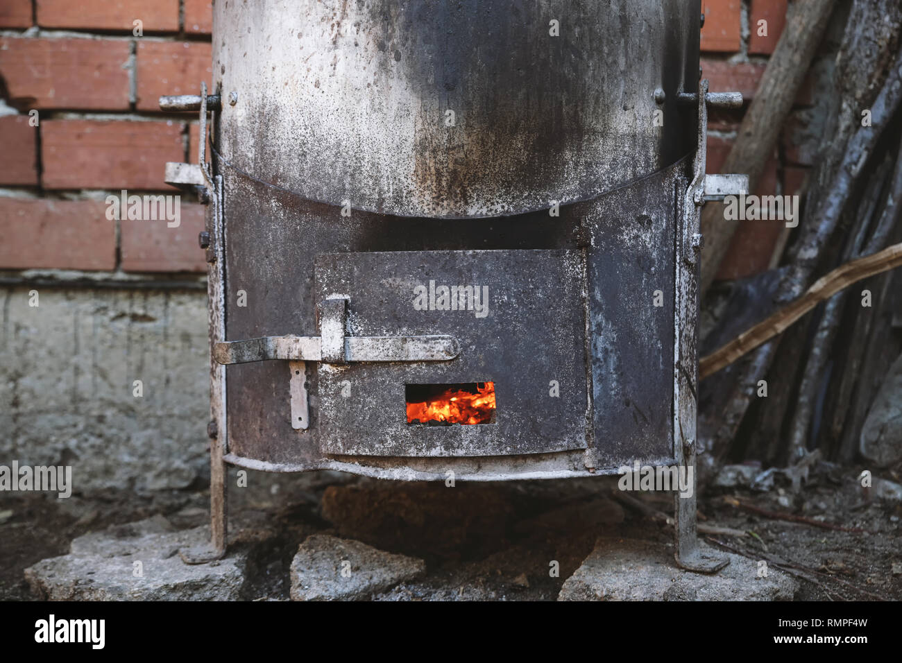 A closeup shot of pieces of wood burning inside old metal oven Stock Photo  - Alamy