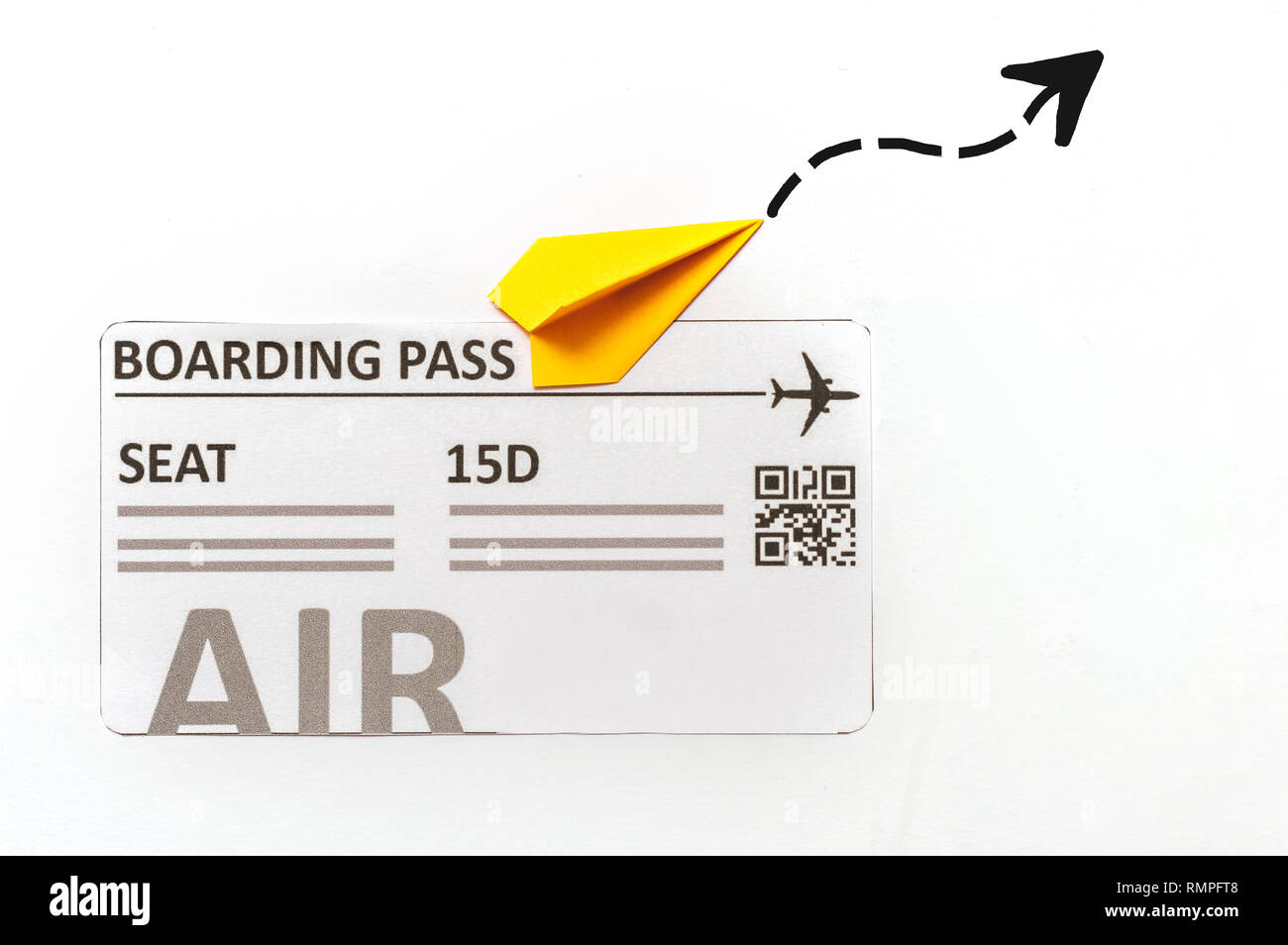 Boarding pass beside a little paper airplane. Travel concept Stock Photo