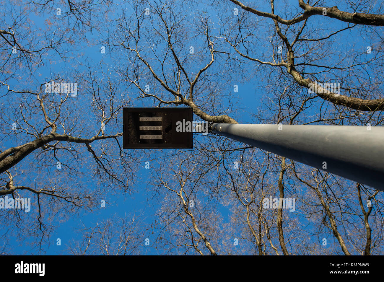 15 February 2019, Hessen, Frankfurt/Main: An intelligent street lamp stands on a footpath in Frankfurt. The lamps are part of a pilot project and are designed to save energy by registering, for example, when a pedestrian passes by and then shines brighter. Otherwise, they should reduce their luminosity. (to dpa 'Frankfurt with 'intelligent' lanterns so far not satisfied' from 16.02.2019) Photo: Silas Stein/dpa Stock Photo