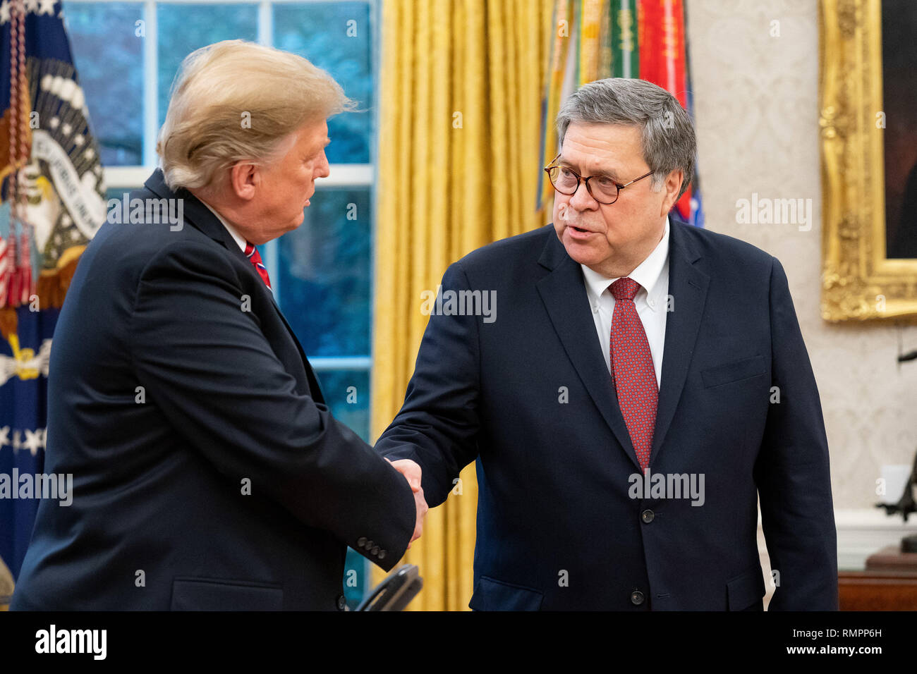 President Donald J. Trump shakes hands with William P. Barr in the Oval Office of the White House Thursday, Feb. 14, 2019, after Barr was sworn-in as the new United States Attorney General.  People:  President Donald Trump,  William P. Barr Stock Photo