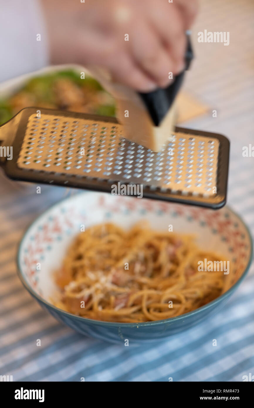 grinding parmesan cheese to carbonara Stock Photo Alamy