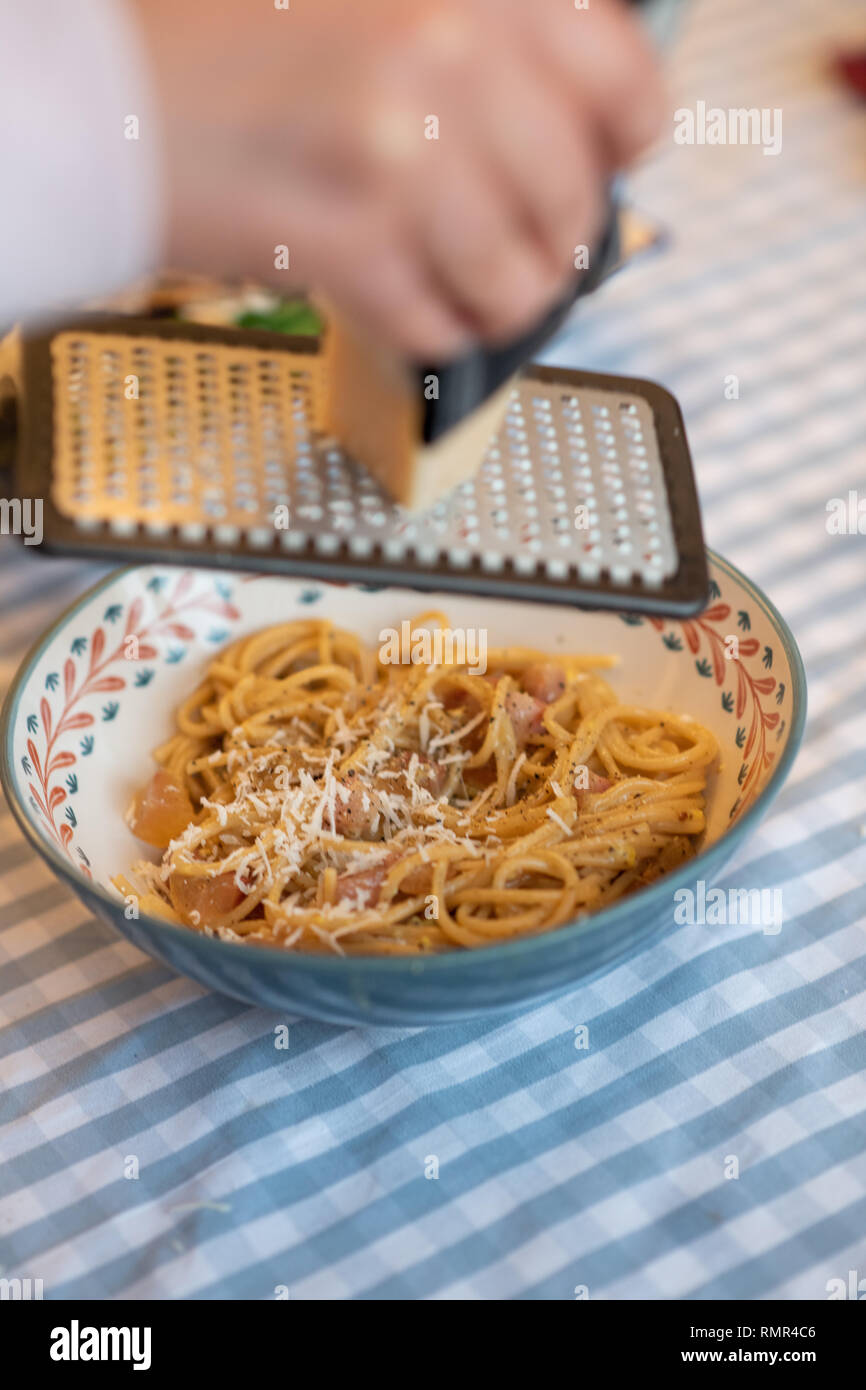 grinding parmesan cheese to carbonara Stock Photo Alamy