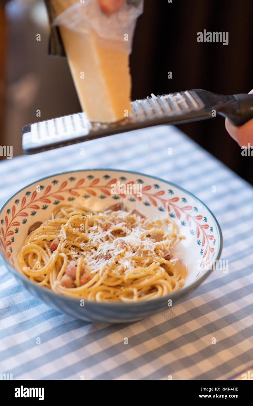 grinding parmesan cheese to carbonara Stock Photo Alamy