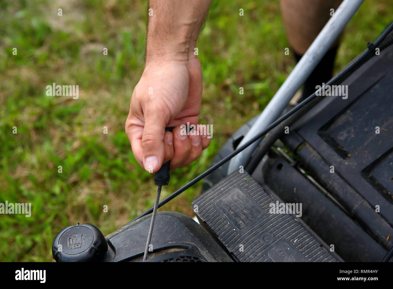 Starting an lawn mower to mow lawns. Stock Photo