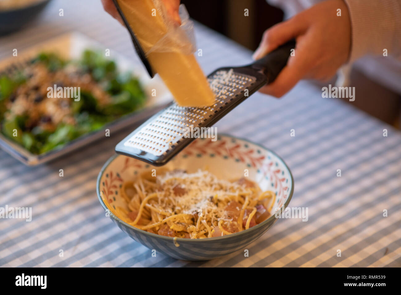 grinding parmesan cheese to carbonara Stock Photo Alamy