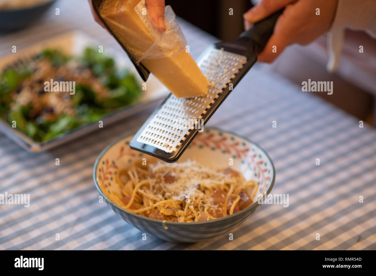 grinding parmesan cheese to carbonara Stock Photo Alamy