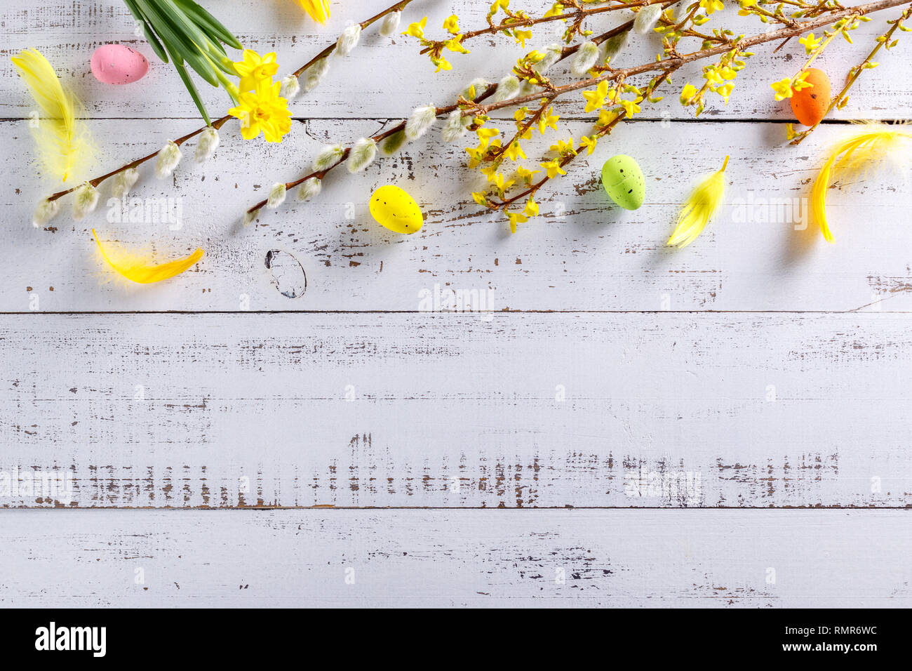 Easter flat lay background with spring flower, willow and easter eggs. Stock Photo
