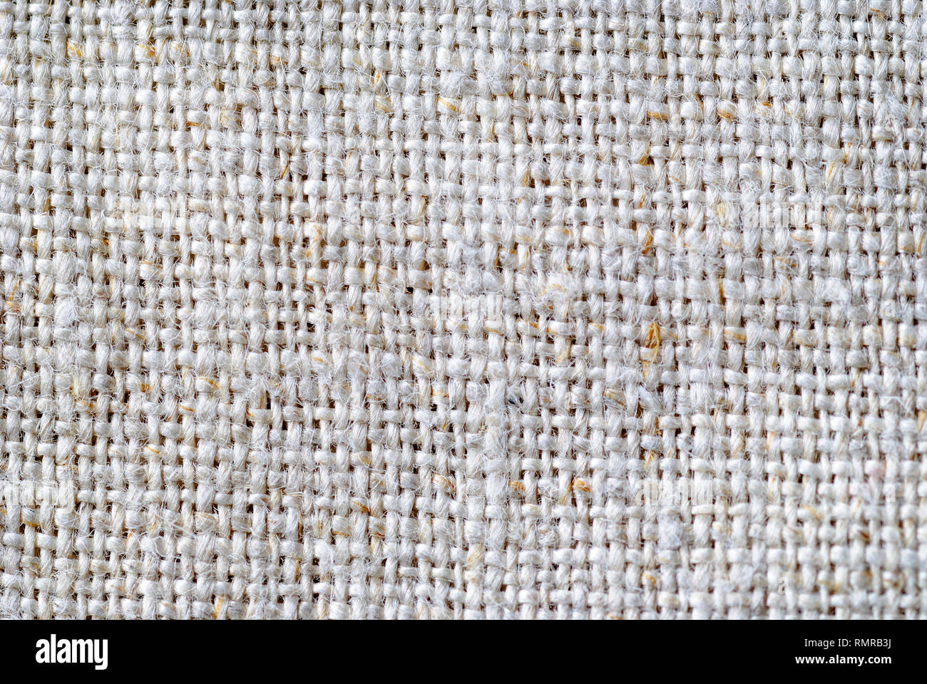 Close up on the weave of natural linen fabric in a neutral color in a full frame background texture Stock Photo