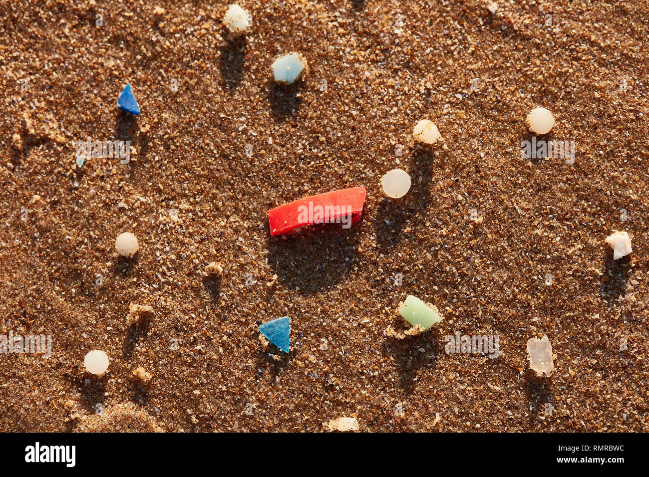 micro plastic nurdles on sand 2 Stock Photo