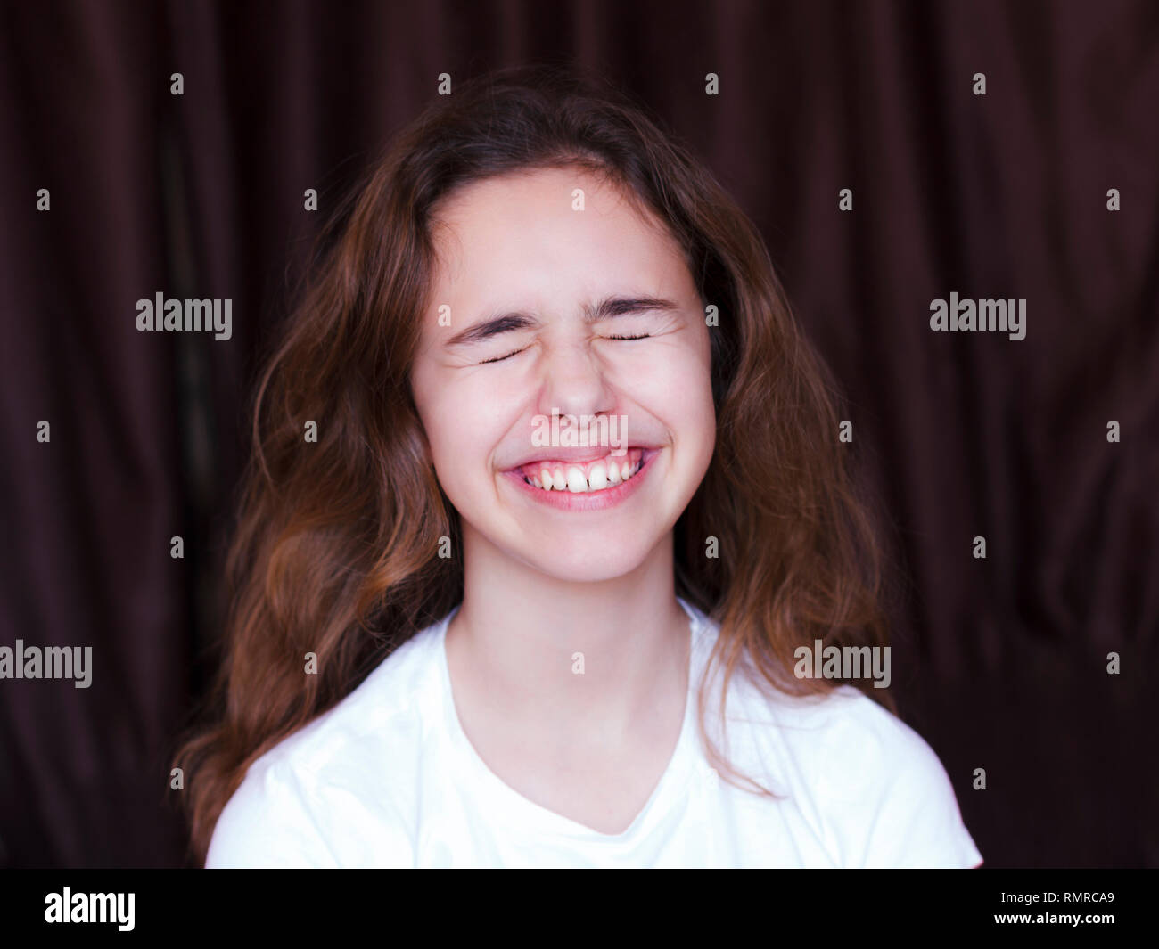 Pretty teenager girl with long hair makes very funny face and laughing with the closed eyes Stock Photo - Alamy Pretty teenager girl with long hair makes very funny face and laughing with the closed eyes Stock Photo - Alamy