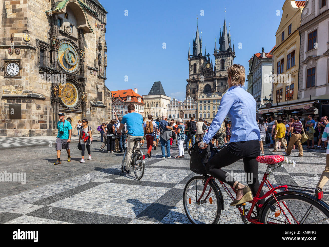 Prague tourists riding bike, Old Town Square Tourism on bicycle Czech Republic Stock Photo