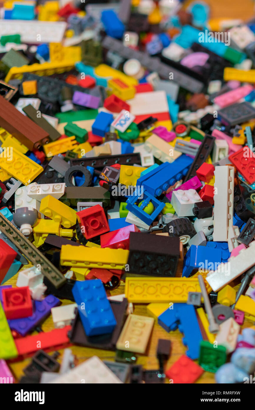 Close up of colorful plastic bricks on the floor. Early learning. Children's plastic constructor on the floor. background. vertical photo. Stock Photo