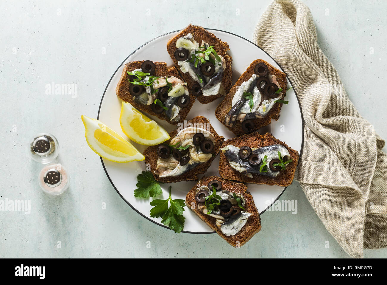 sandwiches with sardines marinated in olive oil with garlic and rye